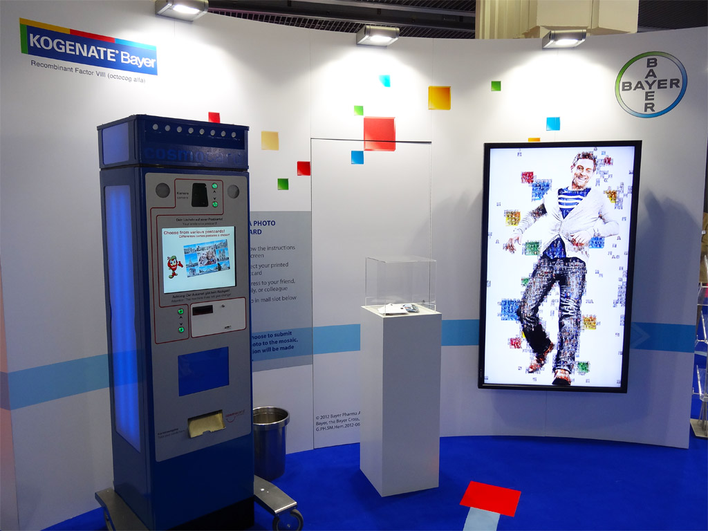 Booth layout showcasing the real-time photo mosaic setup at Bayer, Paris