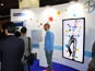 Guests interacting with the live digital mosaic booth at Bayer, Paris