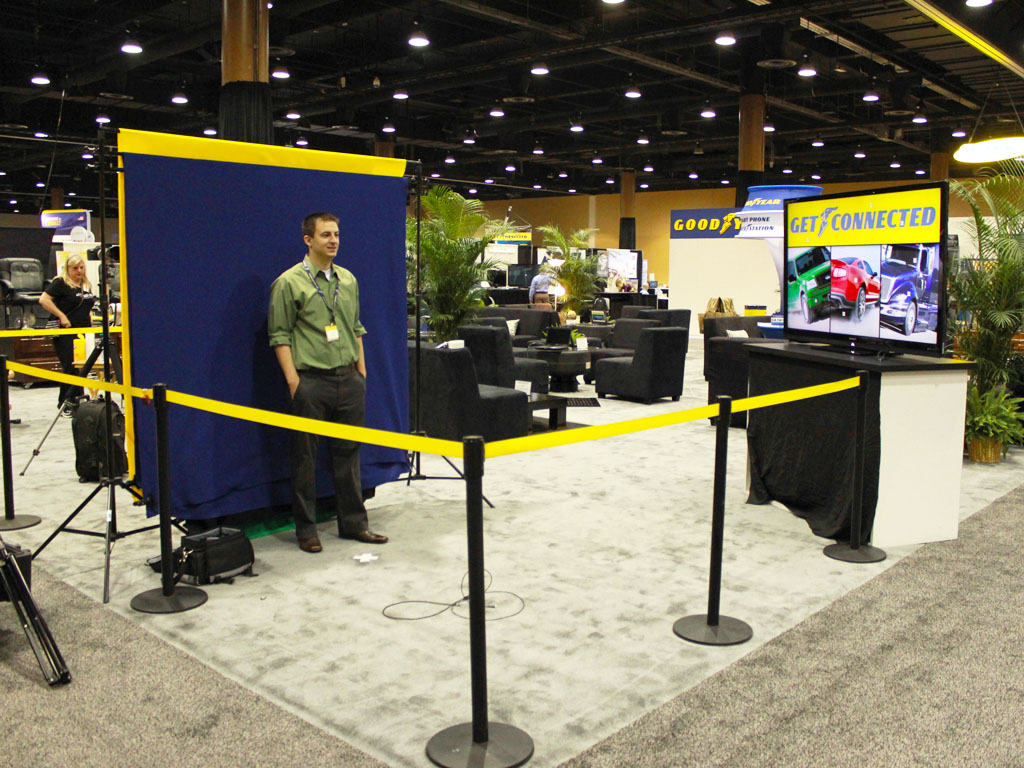 Overview of the Goodyear booth with mosaic display and guest interaction zones