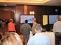 Far shot of guests analyzing the completed Live Digital Mosaic at the Nestlé Conference