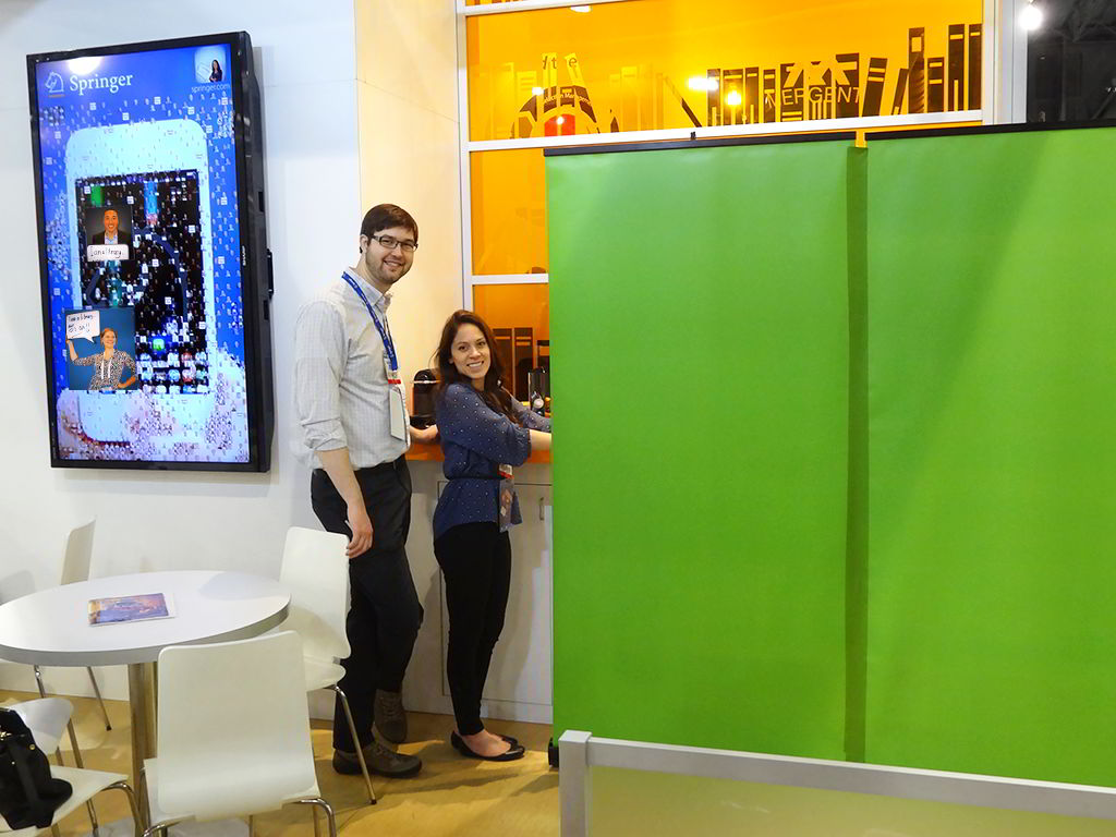 Event tech standing beside the interactive digital mosaic display at Springer’s ALA booth