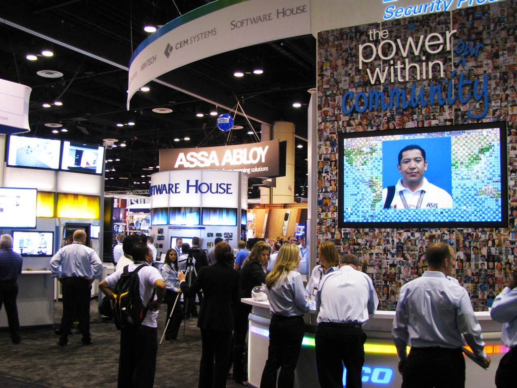 Tyco ASIS 2011 booth with guests interacting near the Live Digital Mosaic display
