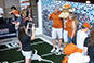 Brand ambassador using a tablet to capture a guest's photo for the Live Print Mosaic at the Texas Longhorn Orange-White Spring Game