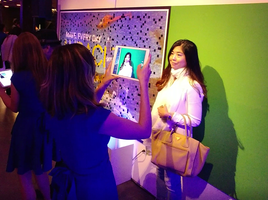 Brand ambassador photographing a guest for the Skyy and Wired mosaic